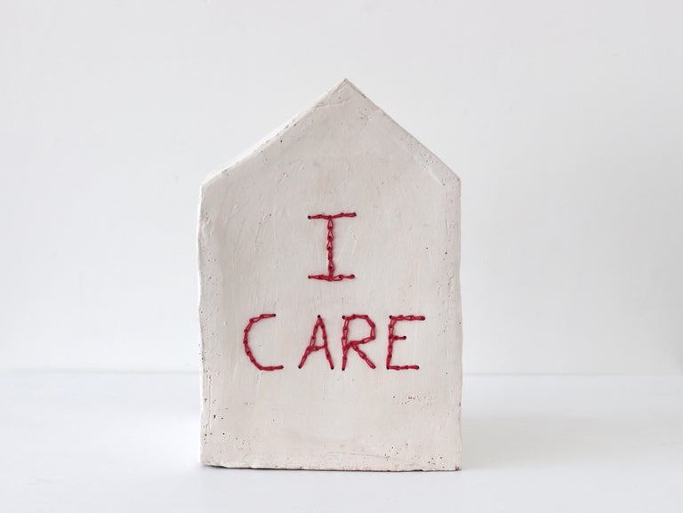 "Accoglienza - MultiverCity (I care)" by contemporary Italian artist Camilla Marinoni is a ceramic sculpture embroidered with cotton thread. The artwork is part of a series that each symbolizes a unit in the fabric of a large city. A peaceful oasis