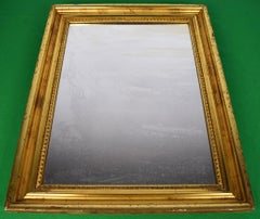 "Antique Mirror w/ Ornate Gilt Frame" (Espejo antiguo con marco dorado ornamentado)