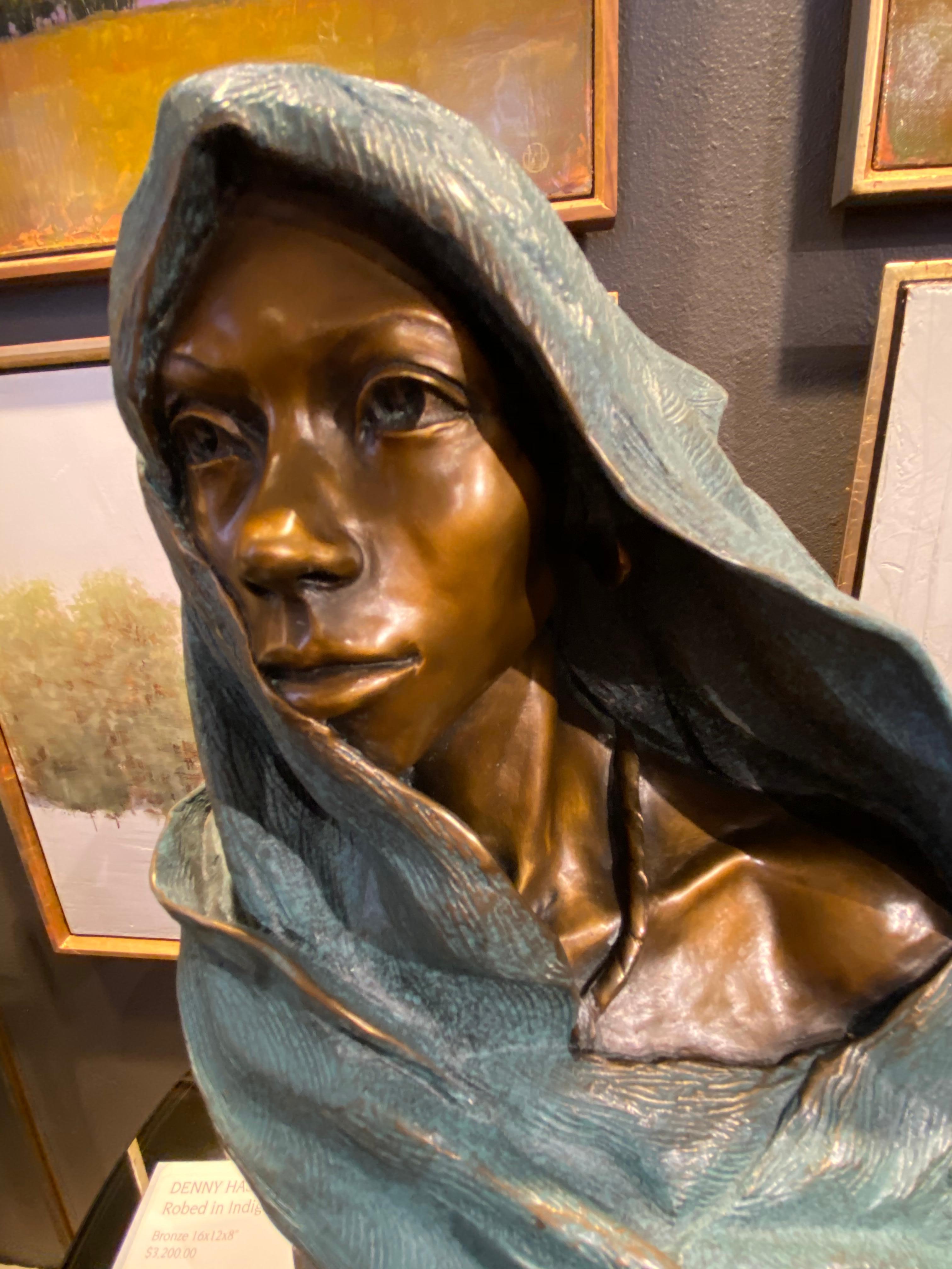 Robed in Indigo by Denny Haskew
Figurative Bronze Female Bust, mounted on granite and walnut base with turntable and brass nameplate as pictured. Features a gorgeous patina that is opaque blues and traditional french brown to accentuate the