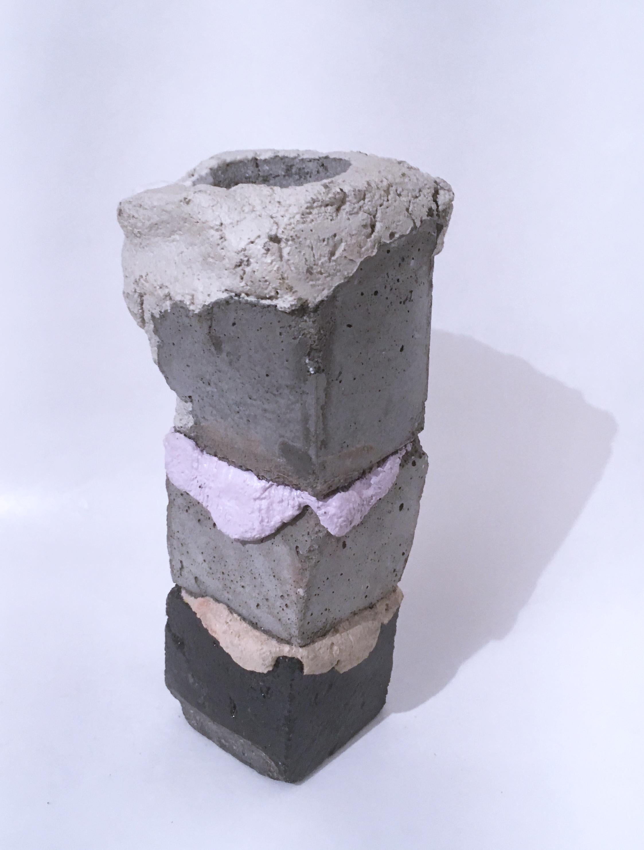 Biomorphic yet industrial style to Dena Paige Fischer's sculptural votive candle holder.  The stacked cubes are painted and smooth, piled upon one another into a column, or as the artist calls it, a totem.  The pastel pigmented concrete in peach and