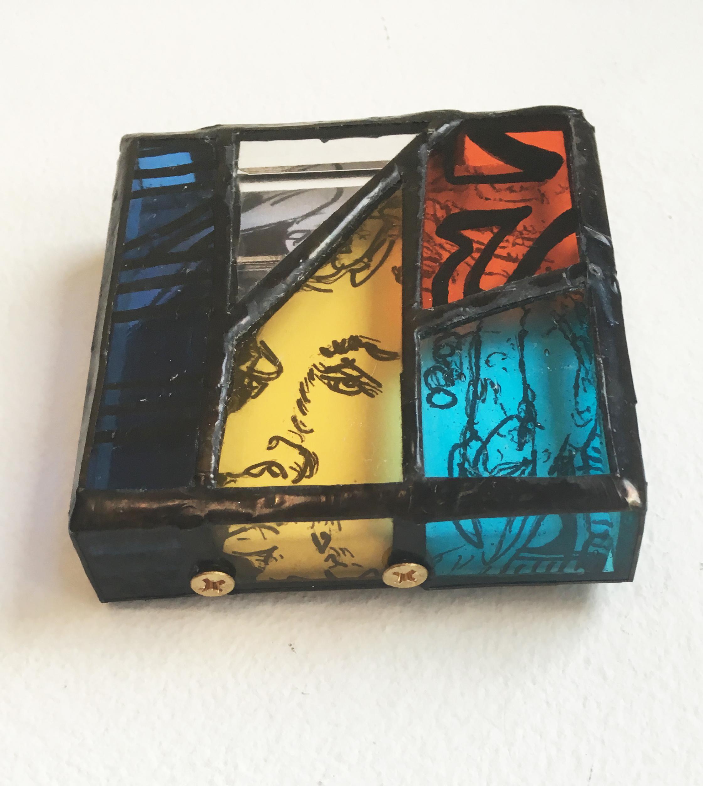 Mr. Tea, a unique stained glass shadowbox handmade by TF Dutchman, contains an ink and paper drawing on canvas set in a stained glass box.  The canvas is a portrait of a musician. The brilliant red, blue, turquoise, and yellow glass with vitreous