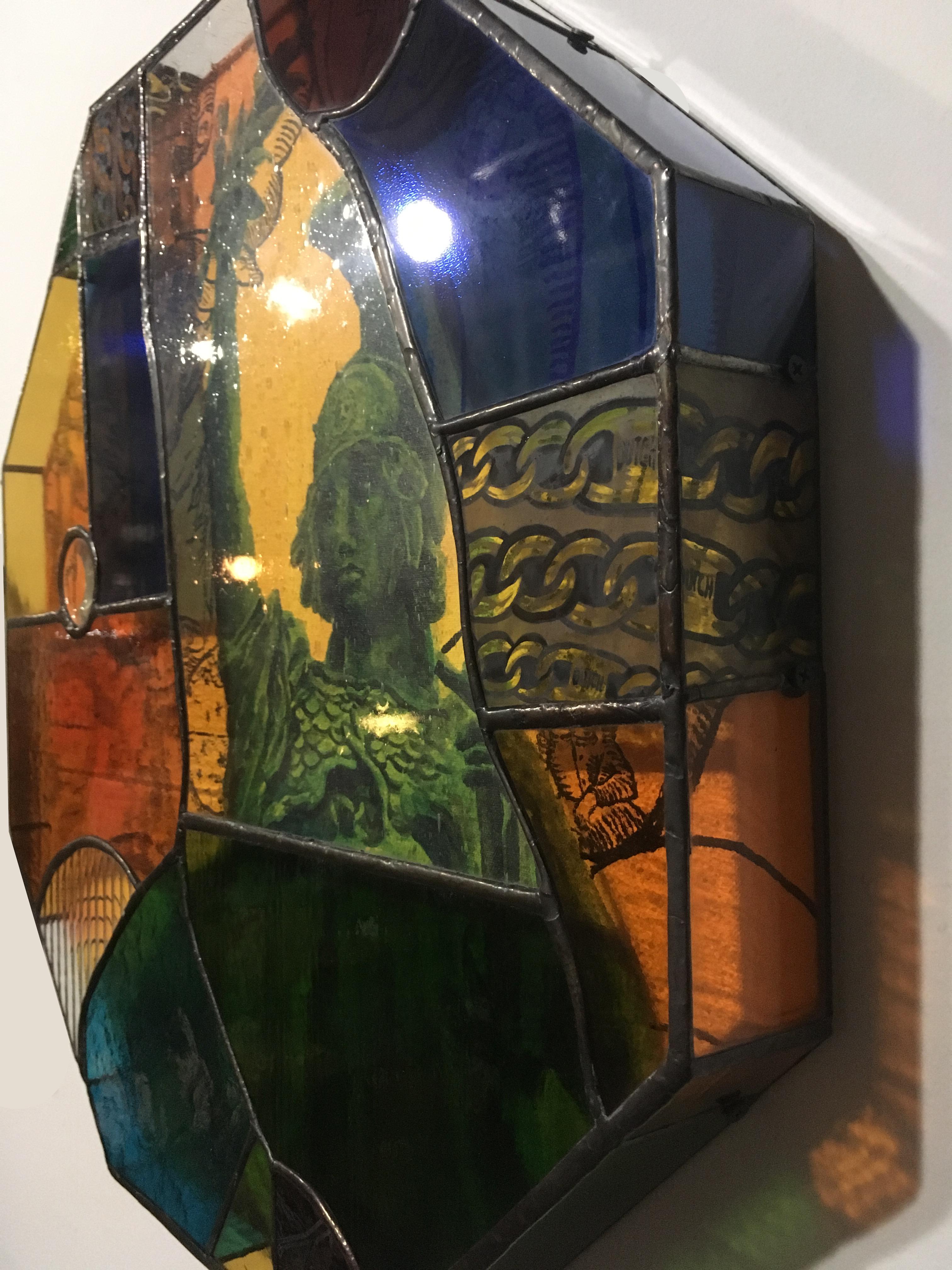Earth People, a unique stained glass shadowbox handmade by TF Dutchman, contains an acrylic painting on canvas set in a stained glass box.  The canvas is a portrait of a statue with alchemy imagery. The brilliant orange, blue, green and yellow glass