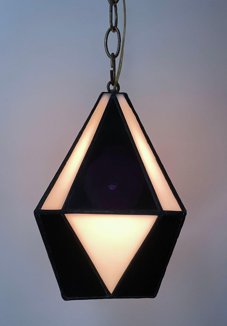 Handcrafted stained glass ceiling lamp with brass hardware, decorators chain and 8ft wall plug with toggle switch. Black and white glass. Ready to hang.  Multiples available but each one is slightly unique by the hand made nature.  Please inquire