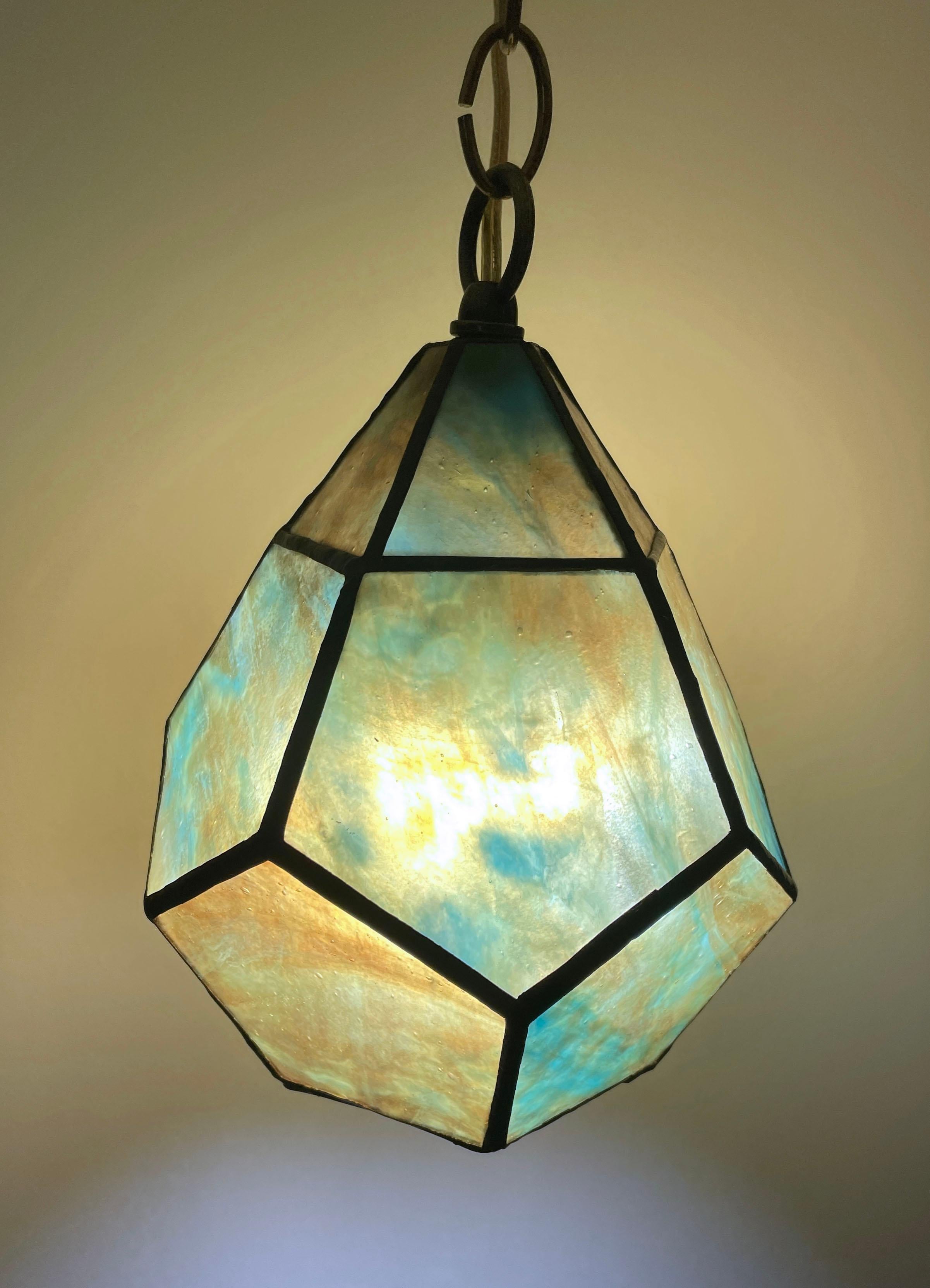 Handcrafted stained glass ceiling lamp with brass hardware, decorators chain and 8ft wall plug with toggle switch. Turquoise and amber glass. Ready to hang.  Multiples available but each one is slightly unique by the hand made nature.  Please