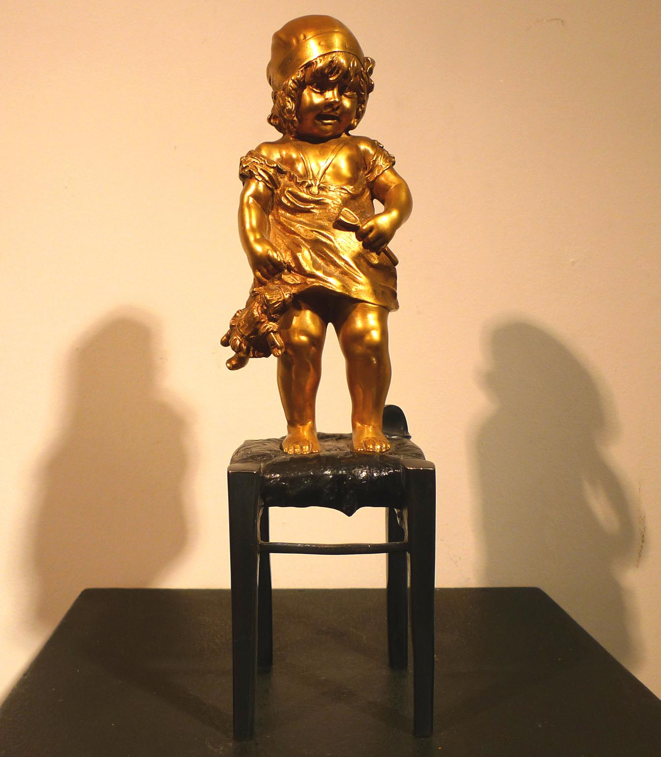 "A Girl Climbed on a Stool Holding a Doll",  20th Century Bronze by Juan Clará