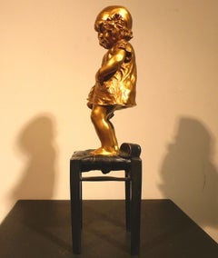 "A Girl Climbed on a Stool Holding a Doll",  20th Century Bronze by Juan Clará