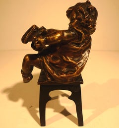 "A Girl Sitting on a Stool Tying Her Shoe", 20th Century Bronze by Juan Clará