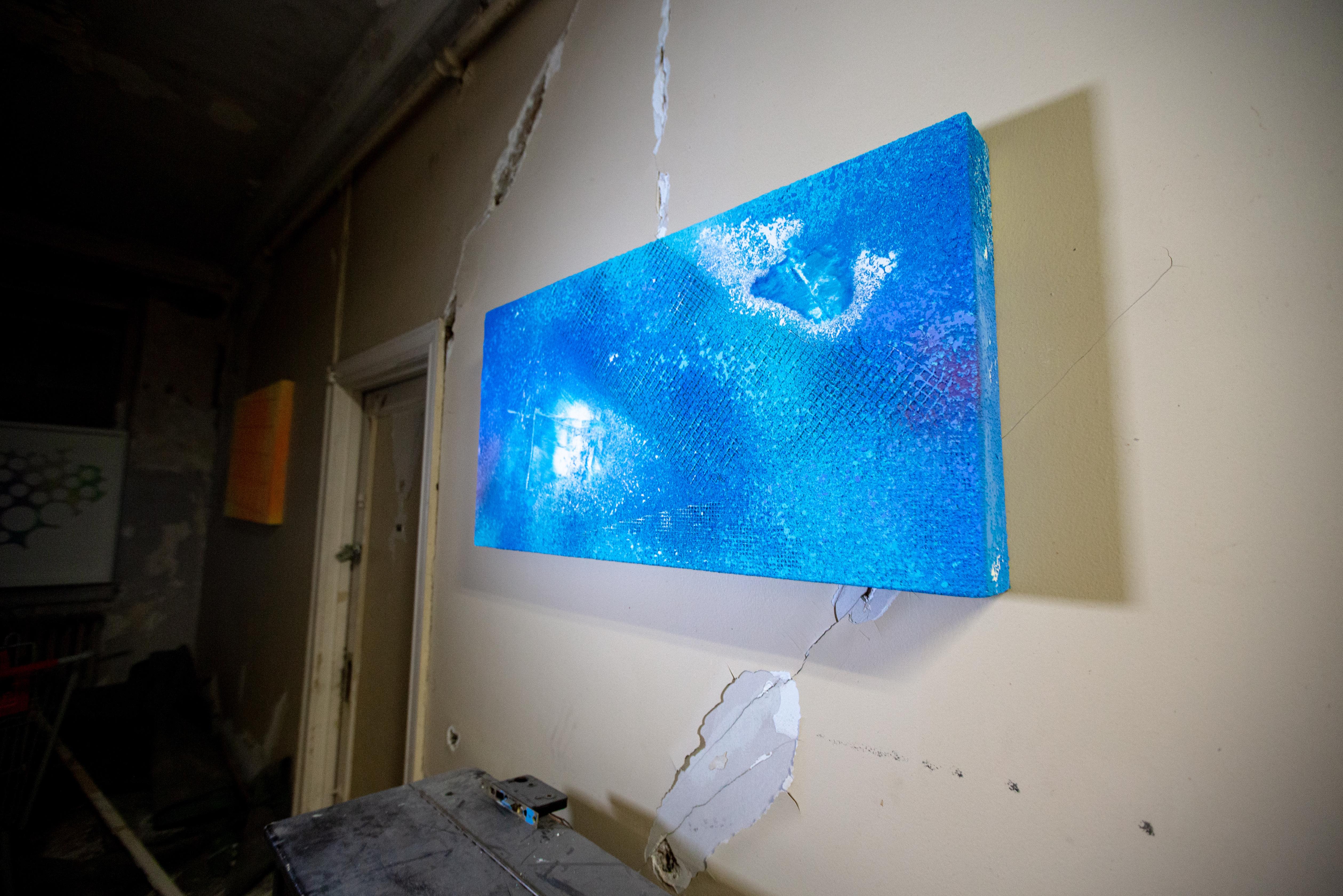 Blue flare, vibrant sky, florescent blue, white and blue mix.
This original piece is a rectangular mixed media painting by Joel Blenz. It is done in multiple materials and shapes to create different textures and illusions. The piece is mostly in