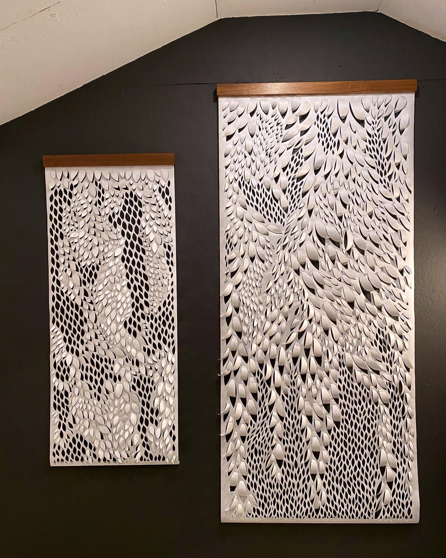 White paper organically cut into leaf like fluid patterns creating a natural hanging sculpture.  Each wall hanging is hand-cut (not laser) out of Tyvek, a synthetic paper that is incredibly durable. These pieces are dust, water, mildew, and tear