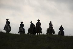 Untitled 4438 - Texas landscape, horseback riders in tall grasses w/ cloudy sky