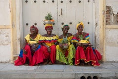 Four Palenqueras - Cartagena, Colombia fruit sellers in red, yellow & blue