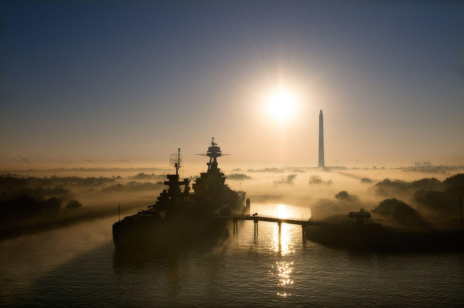 Lou Vest Color Photograph - USS Texas - Ship channel at foggy sunrise with San Jacinto monument