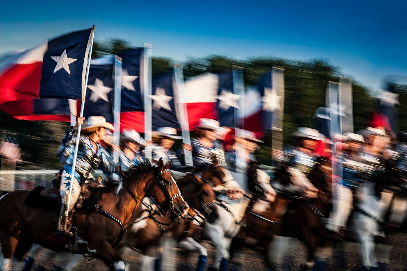 Alan Montgomery Color Photograph - Texas Our Texas - Texan rodeo cowboys horse parade w/ cowboy hats & Texan flag