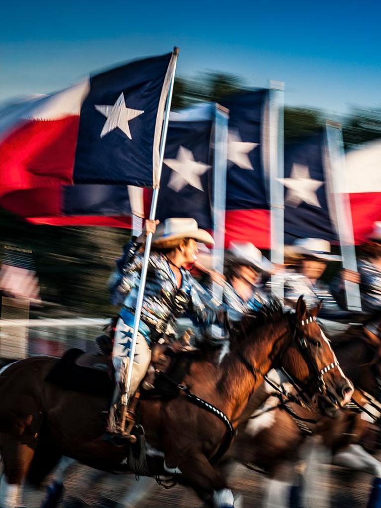 Texas Our Texas - Texan rodeo cowboys horse parade w/ cowboy hats & Texan flag - Photograph by Alan Montgomery