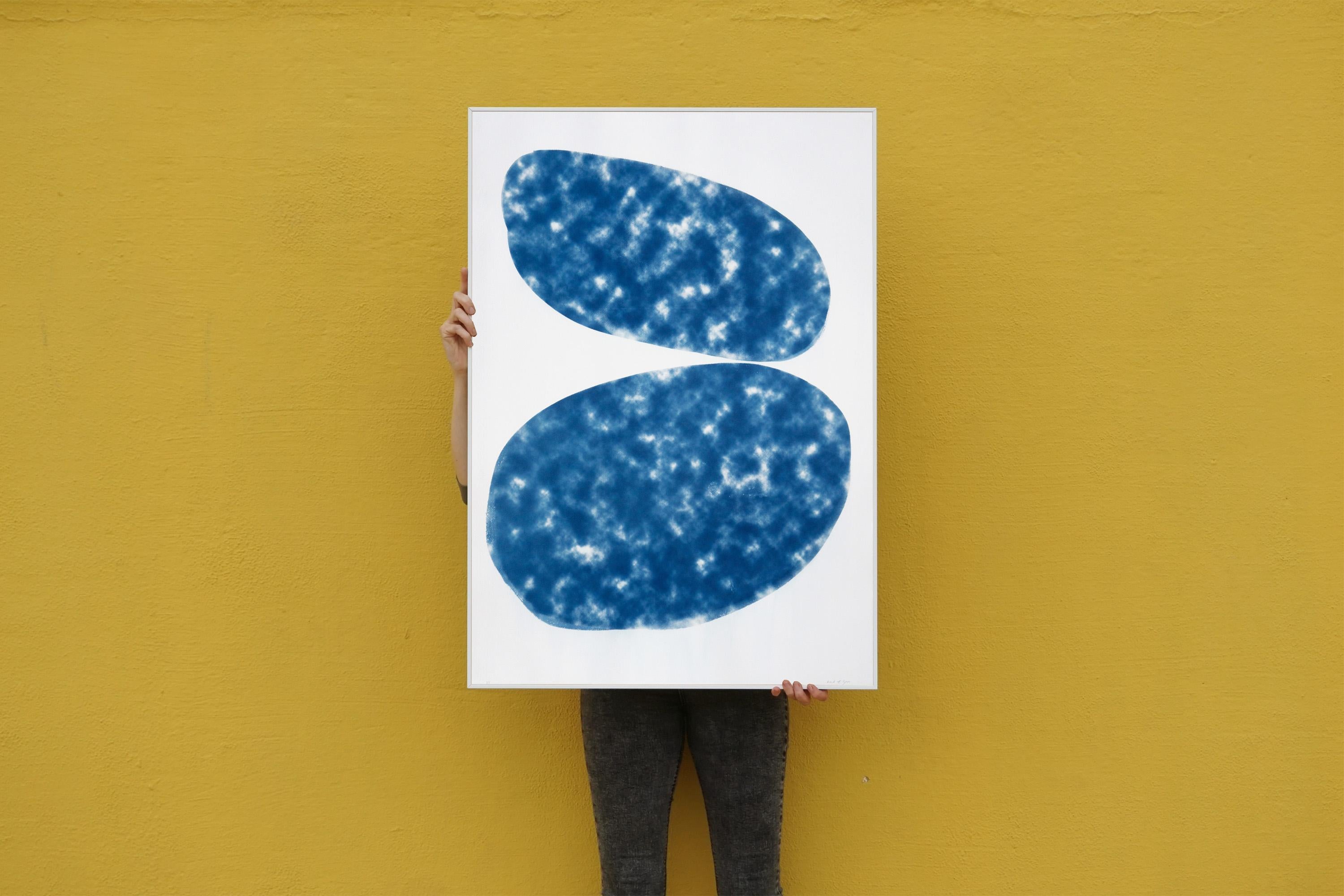 This is a unique cyanotype print of abstracted ovals. The emulsion was hand-painted and exposed using a textured photo negative. 

Please note that there are two small stains and a subtle line on the emulsion side of the print, thus the price