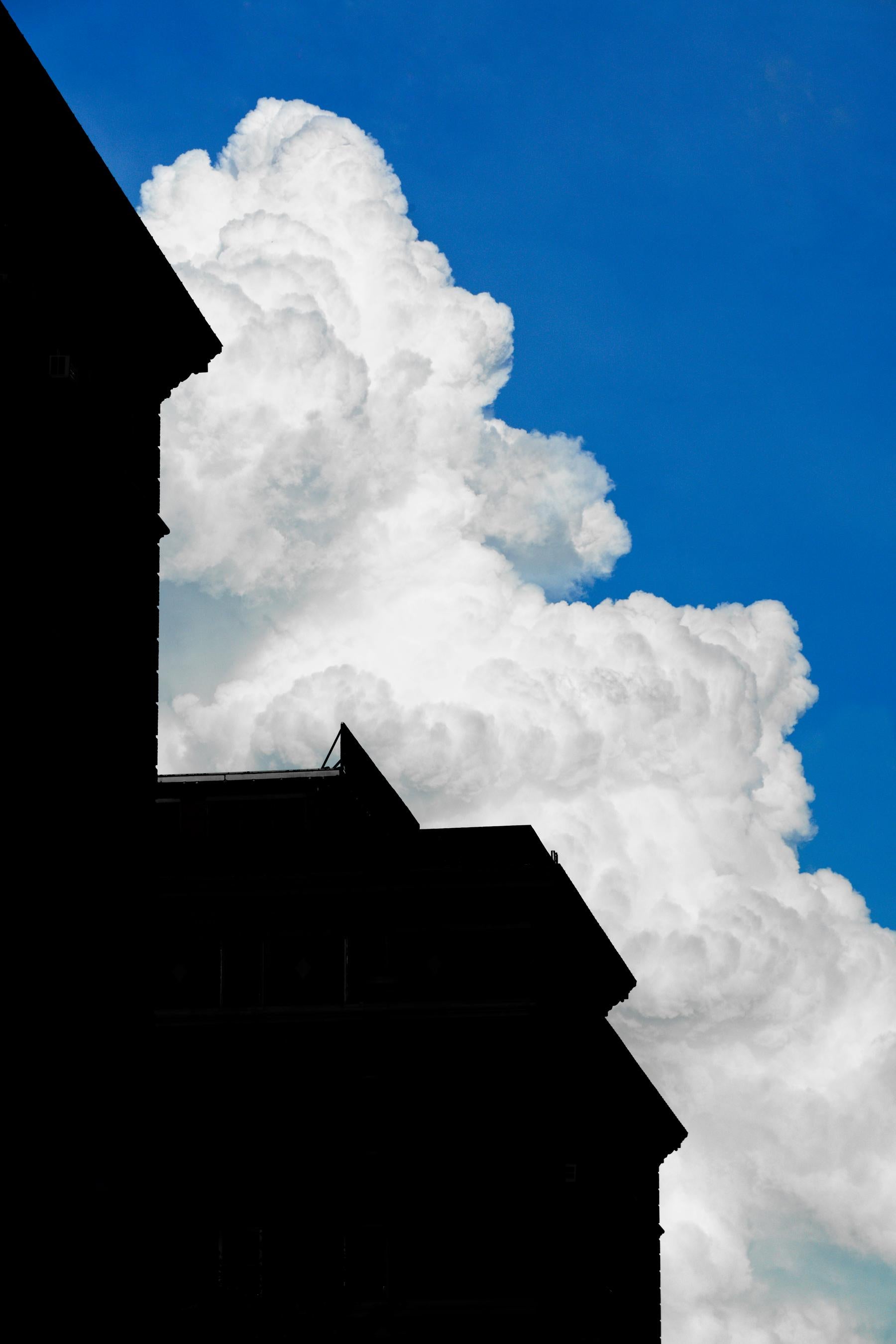 Bob Krasner Color Photograph - "Building With Cloud #2", photography, city, architecture, white cloud, blue sky