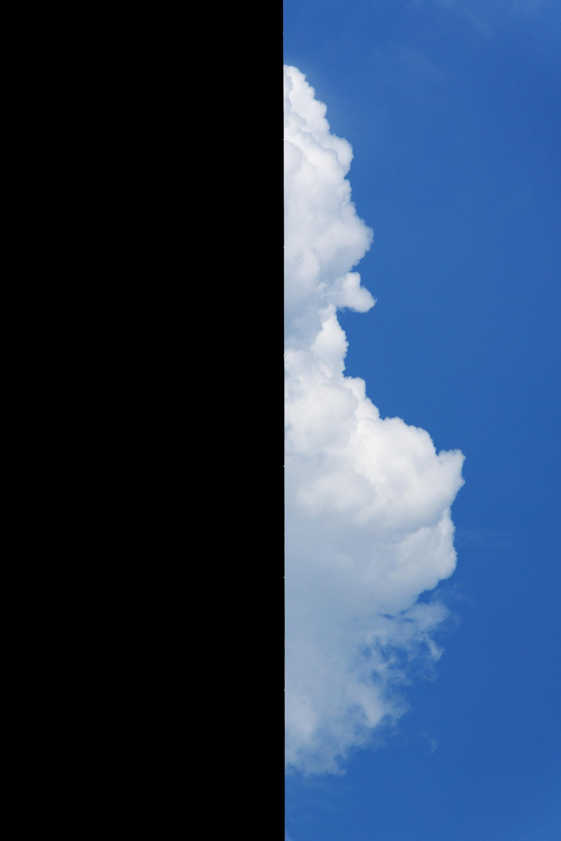 Bob Krasner Landscape Photograph - "Building With Cloud", photograph, city, architecture, geometry, blue sky shadow