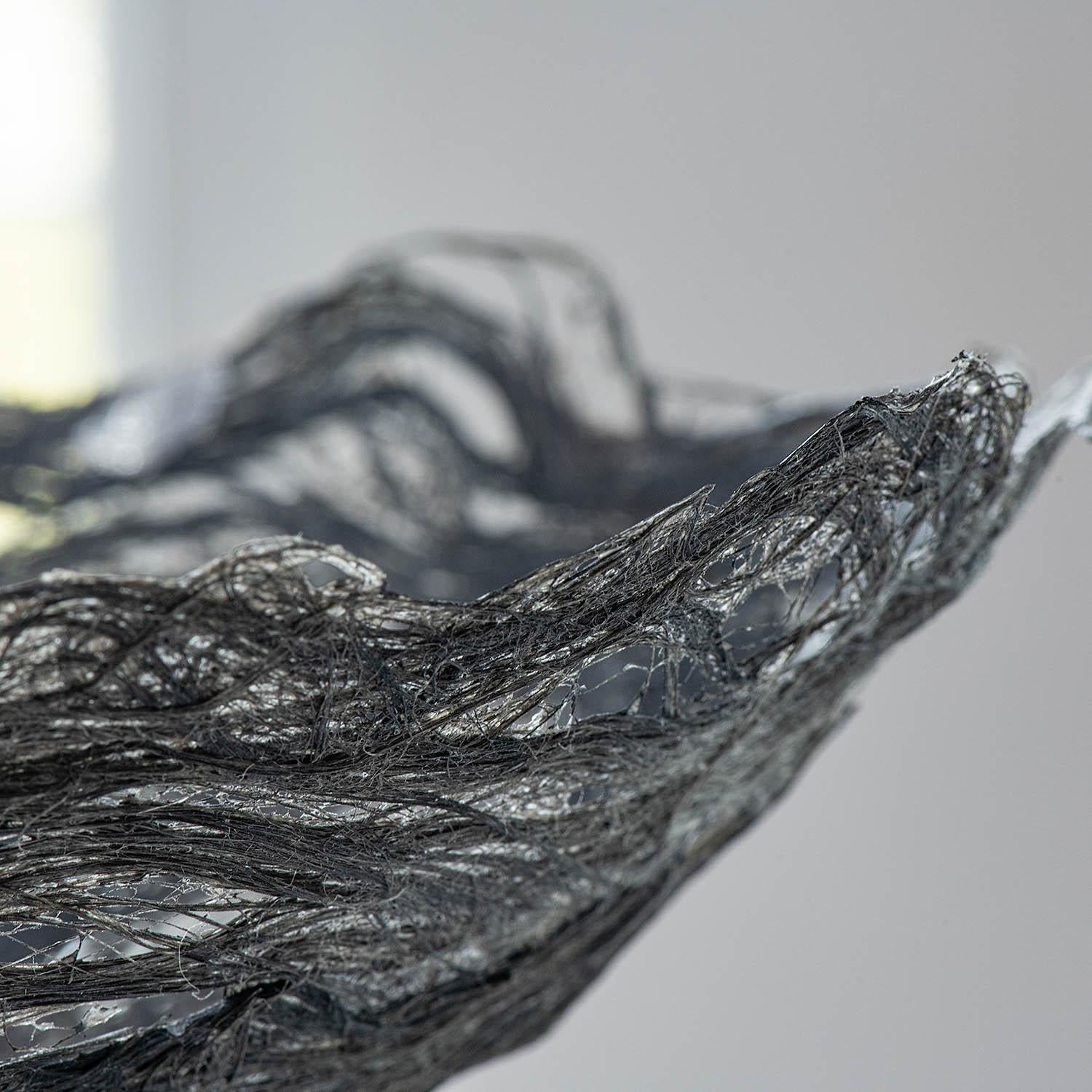 Silver Metallic, Kay Sekimachi, flax, 4” x 11” x 11”, 2008

This uniquely woven bowl sculpture, Silver Metallic (2008), was crafted by American fiber artist Kay Sekimachi (b. 1926, San Fransisco, CA). Sekimachi studied at the California College of