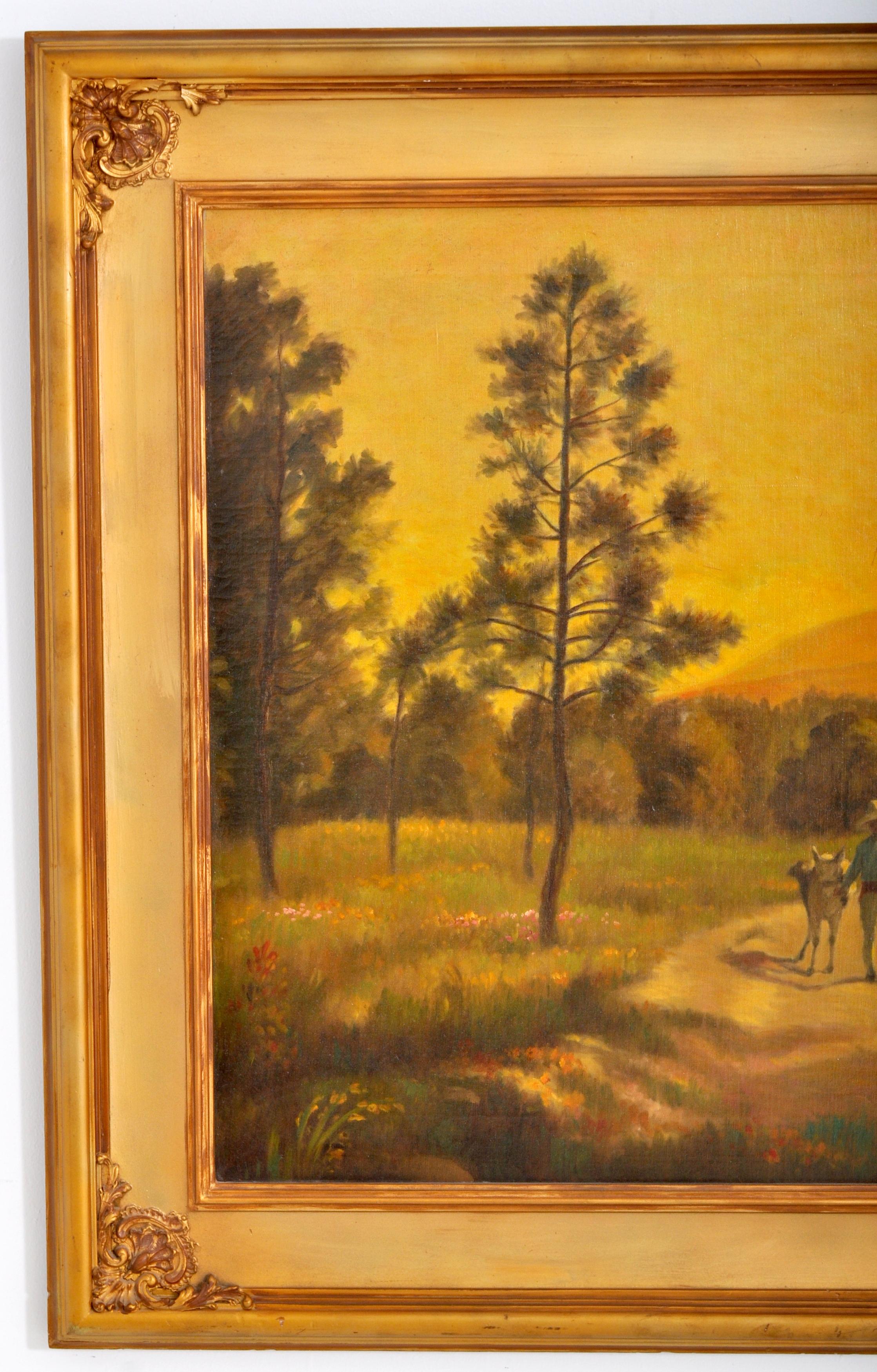 Antique American Oil on Canvas by Charles Holloway (American, 1859-1941), Circa 1915. The painting depicting a South American landscape scene, to the foreground a male figure walking a burro at sunset, the painting of substantial size and in very