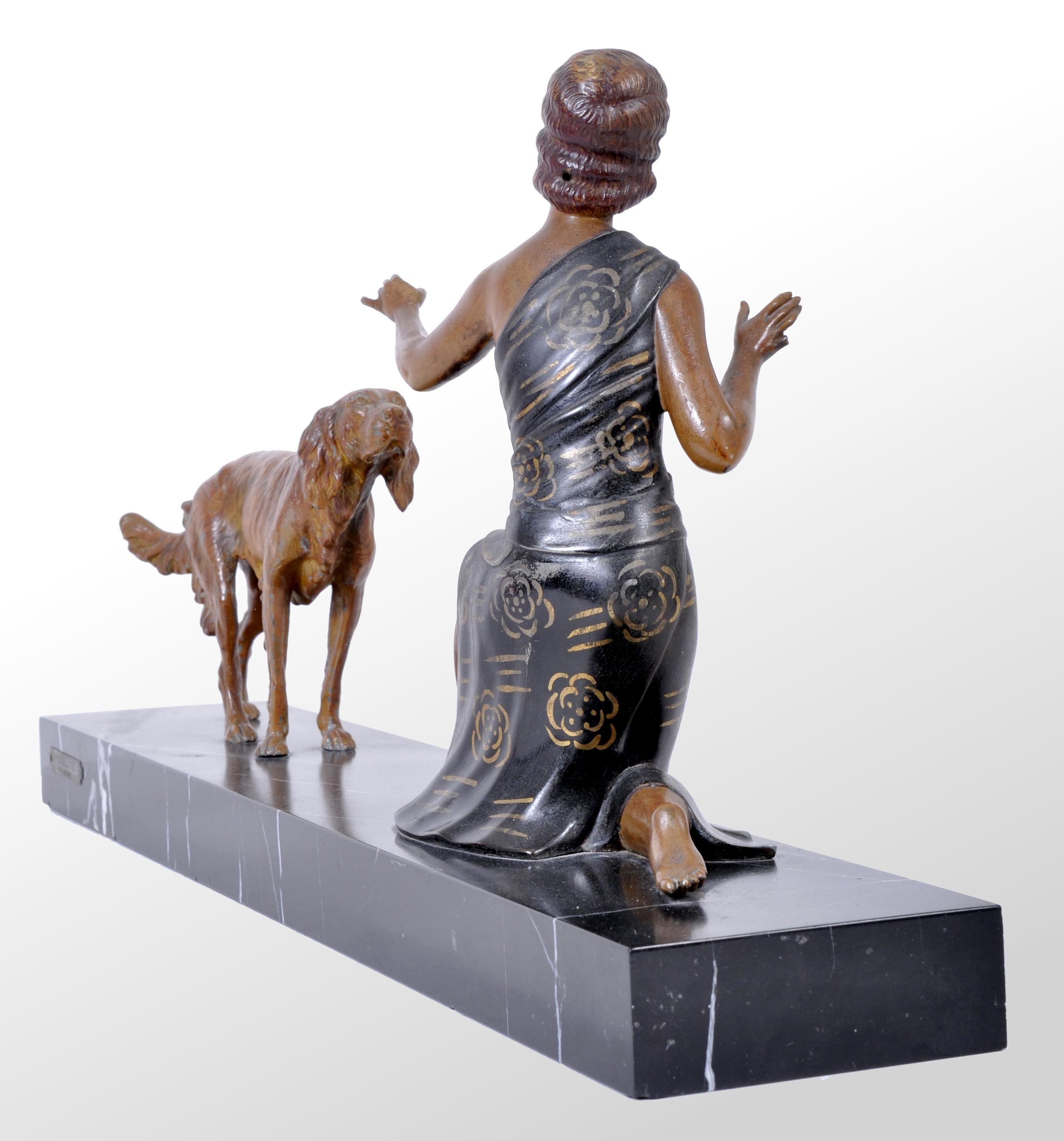 An original Art Deco Bronze / Spelter Figural Group by Enrique Molins-Balleste, circa 1930. A great bronze portraying a stylish Art Deco lady from the age of Jazz, with her hand outstretched to her faithful hound. The bronze mounted on a black
