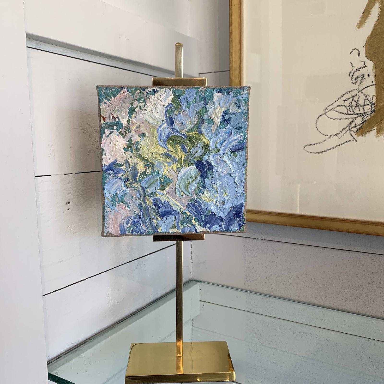 Stunning Mini Oil Painting on Gold Brass Adjustable Art Easel. The gallery currently has a collection of these limited time only small paintings by Stephanie Wheeler. 
The gold brass easel is easily adjustable. The oil itself is a 6 x 6 signed on