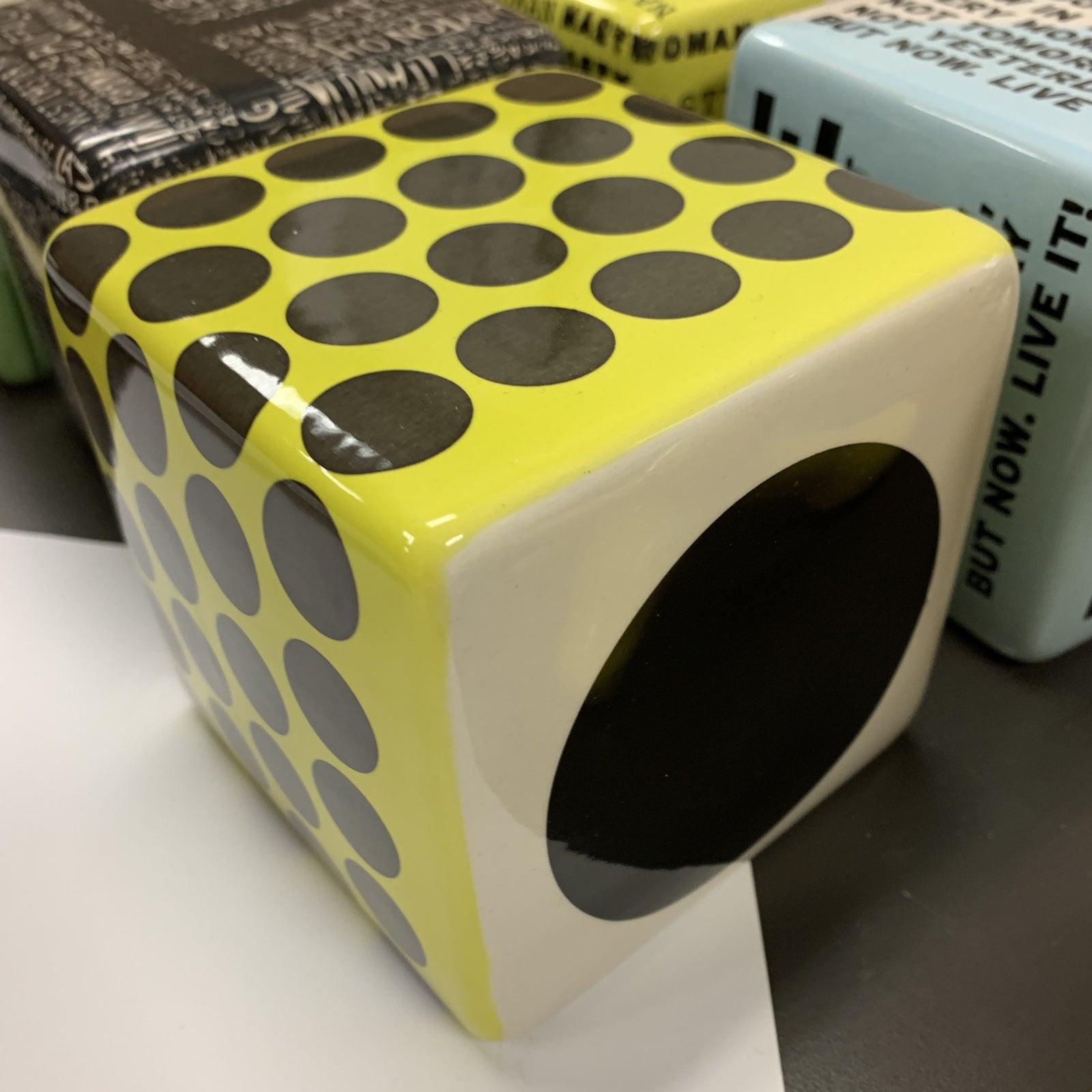 Artist: Kaiser Suidan
4 x 4 x 4
Ceramic Wall Cube Sculpture
Signed on the bottom

Decal has yellow & black dots. hangs very easily on a screw or can be used as tabletop decor.

Bio:
From first generation Lebanese descent, Kaiser Suidan was raised in
