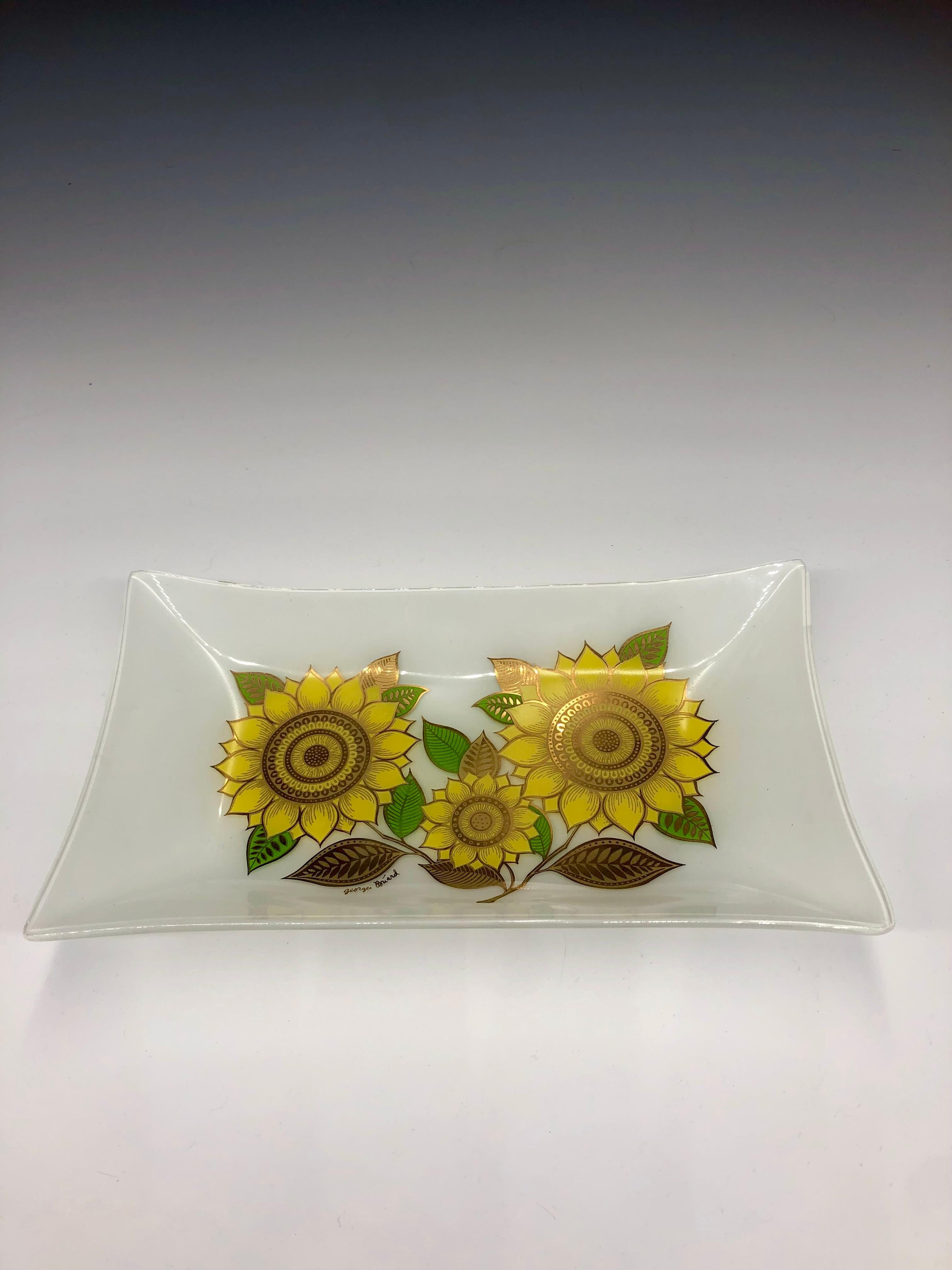 Brighten up your table top with this vintage 1960s Georges Briard glass rectangular sunflower dish / tray. Bold yellow sunflower and green leaf design with gold leaf accents against smoky white background. Signed mid lower left side. 

Georges