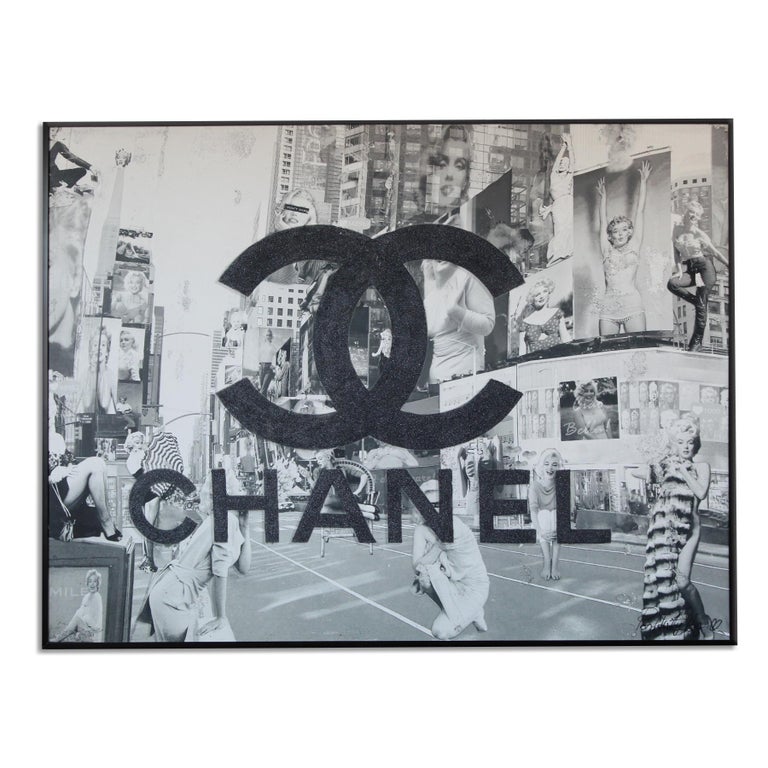'Black Glitter' Framed Canvas Original Pop Art features a black and white collage of Marilyn Monroe images placed in New York City's Times Square, veiled with a glittered Chanel logo. Introspective and playful Italian artist, Arianna Tascione,