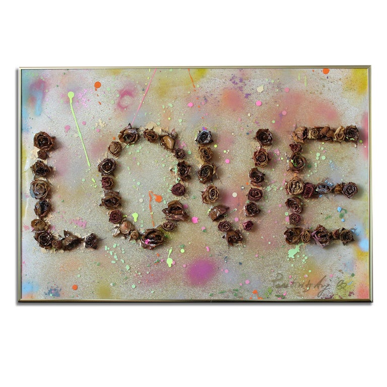 'Love 1.5' Framed Canvas Original Pop Art features dried rosebuds forming the word "Love," adorned with colorful paint splatters in tones of purple, blush, blue, yellow, orange, and green. Introspective and playful Italian artist, Arianna Tascione,