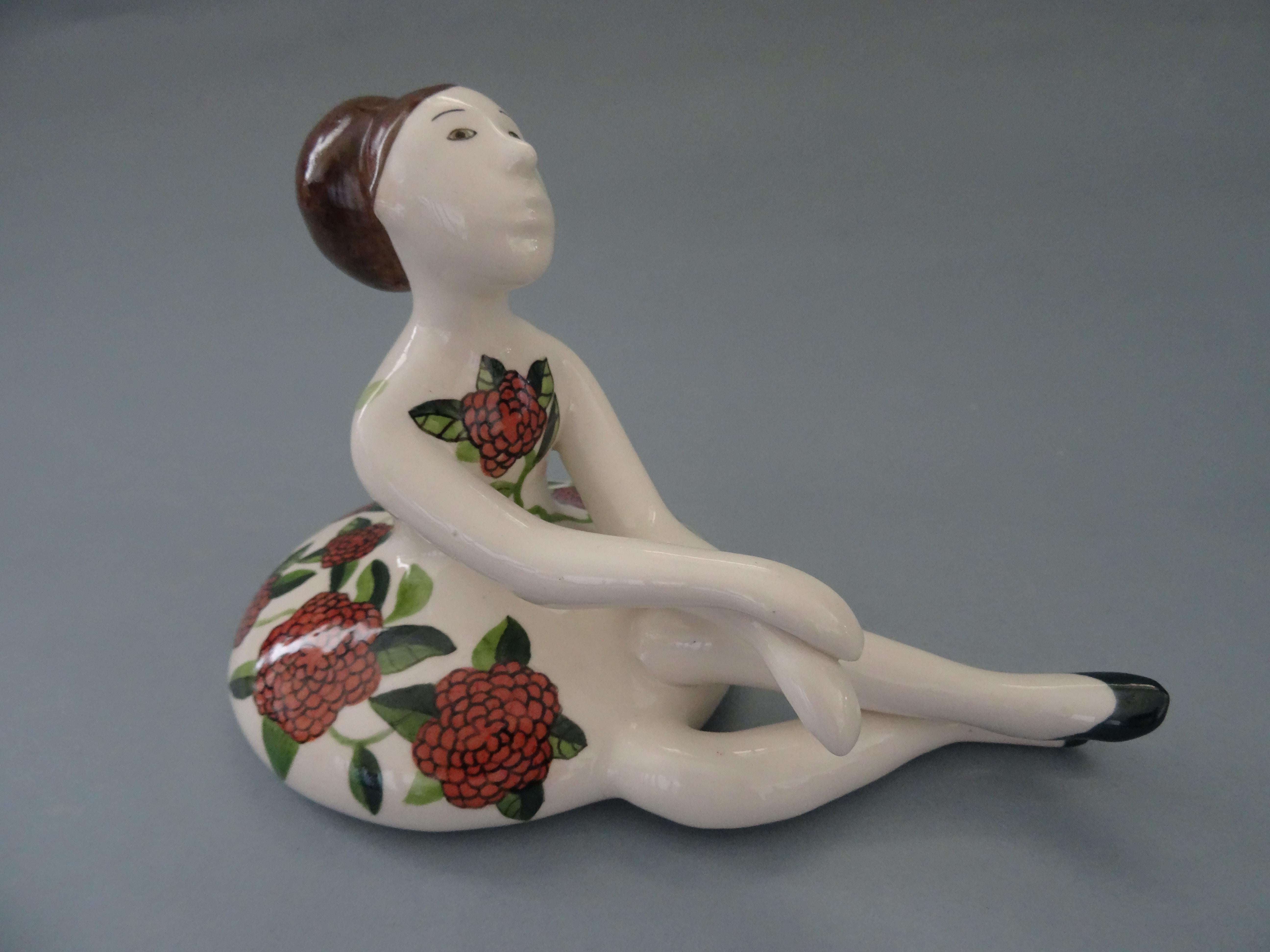 Ballerina 2015. Porcelain, 12x19 cm
(2 of 3)

The Ballerina figurine is a charming piece of porcelain art created in 2015. It features a sitting ballerina, gracefully poised and wearing a lovely flower dress. The ballerina is depicted in a relaxed
