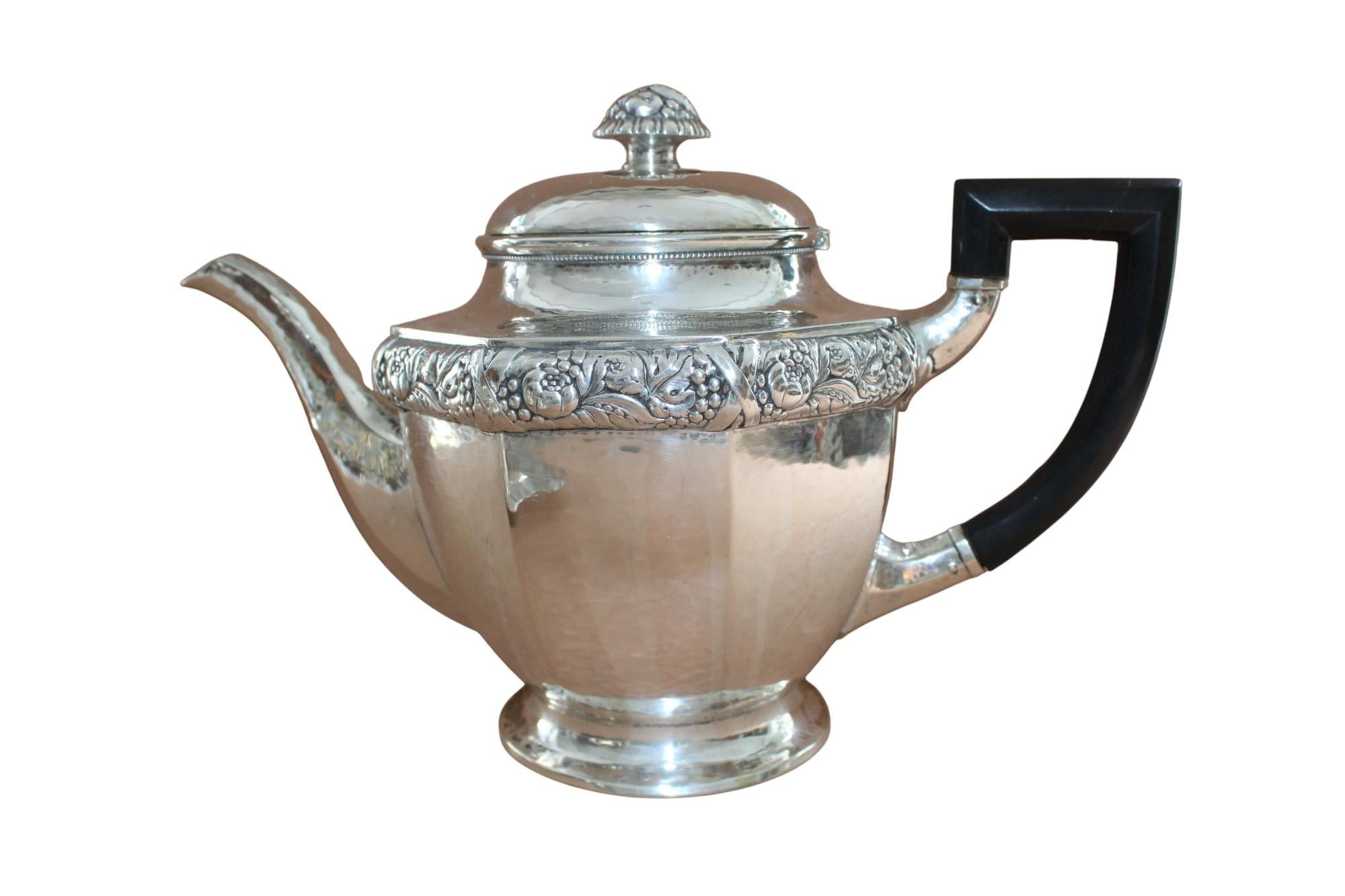 Antique art deco silver tea service by Laurits Berth(1857-1917). Consists of: teapot (h.19cmxl.27cmxw.14cm;volume 1.5 l), milk jug(h.10cmxl.15cmxw.9cm), sugar bowl(h.14cmxl.18cmxw.12cm), tray(30x21cm), weight 1,843 kg.