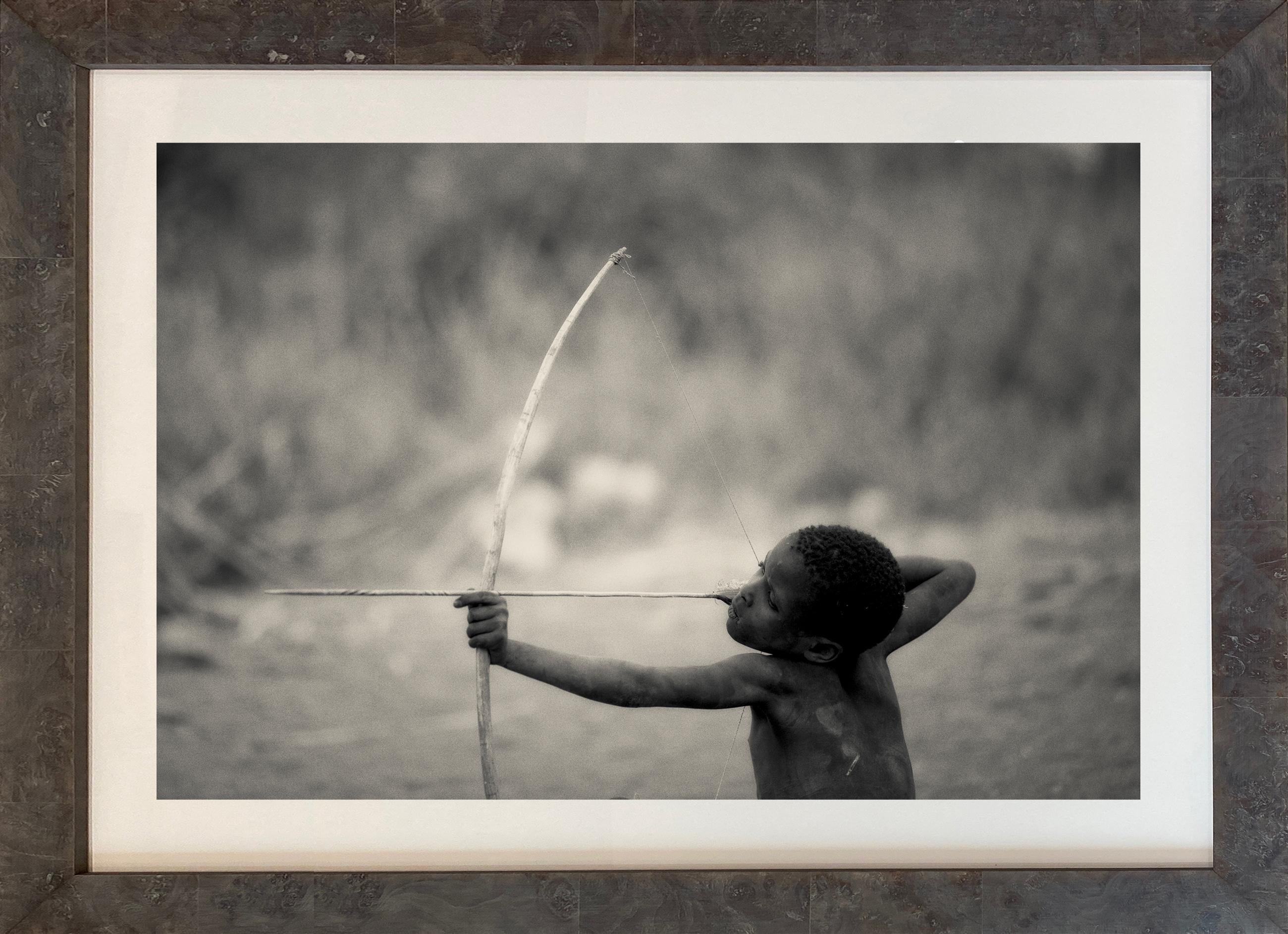 'HADZABE,' Tanzanian Child with Bow, Black and White Photograph by Nicol Ragland