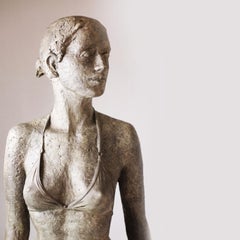 Ebb- contemporary bronze sculpture of life-size Bikini Woman walking confidently