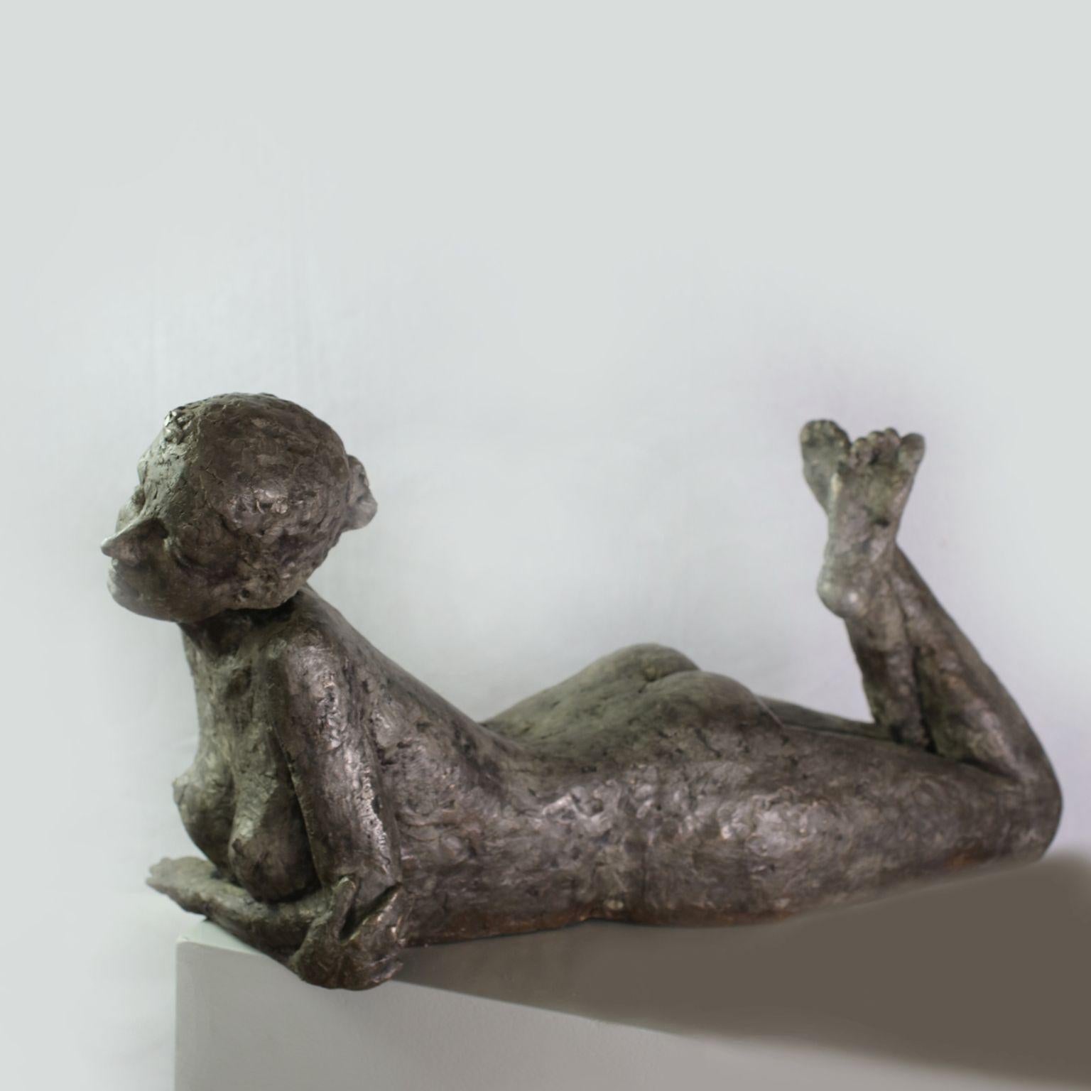 Susanne Kraisser Figurative Sculpture - Stranded - contemporary bronze sculpture of lying nude female resting on her arm