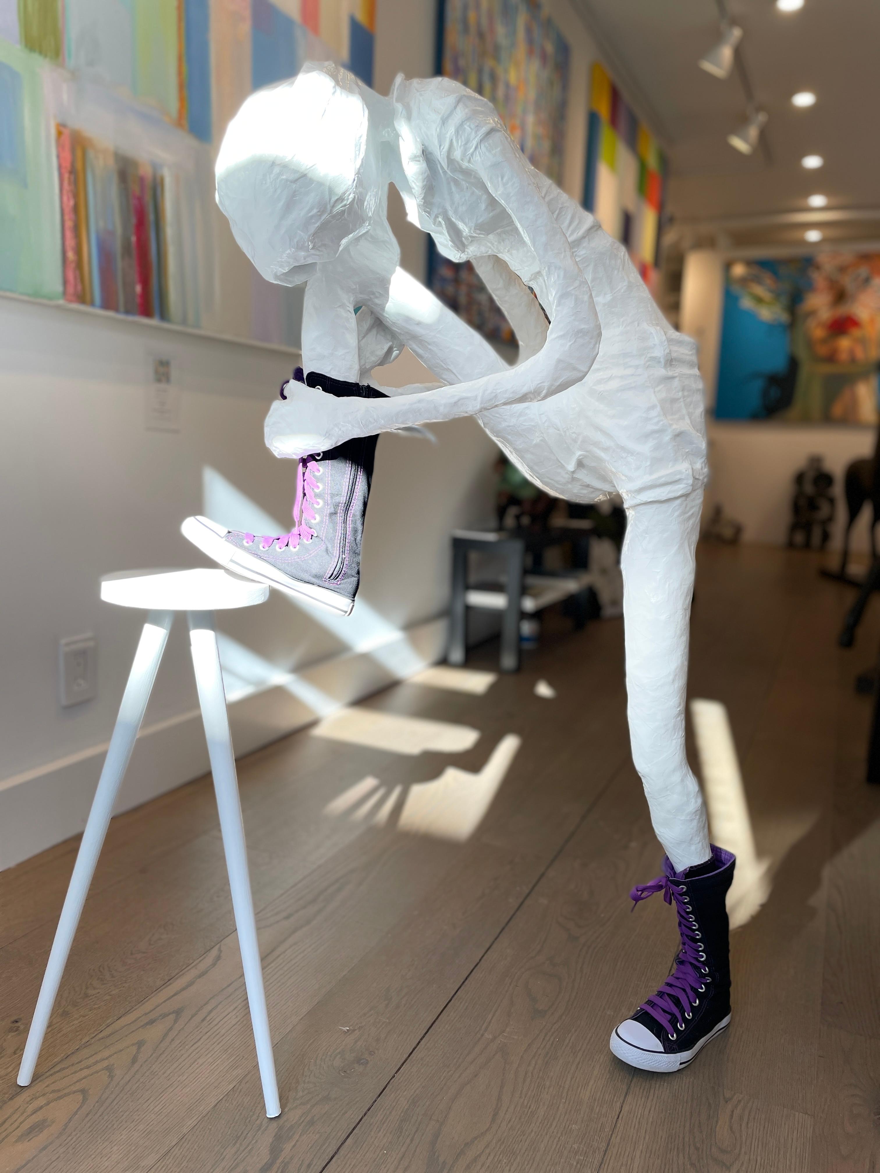Floor Sculpture of a Girl Tying Her Shoe on a Stool. Title - Girl Tying Her Shoe - Brown Figurative Sculpture by Bret Reilly