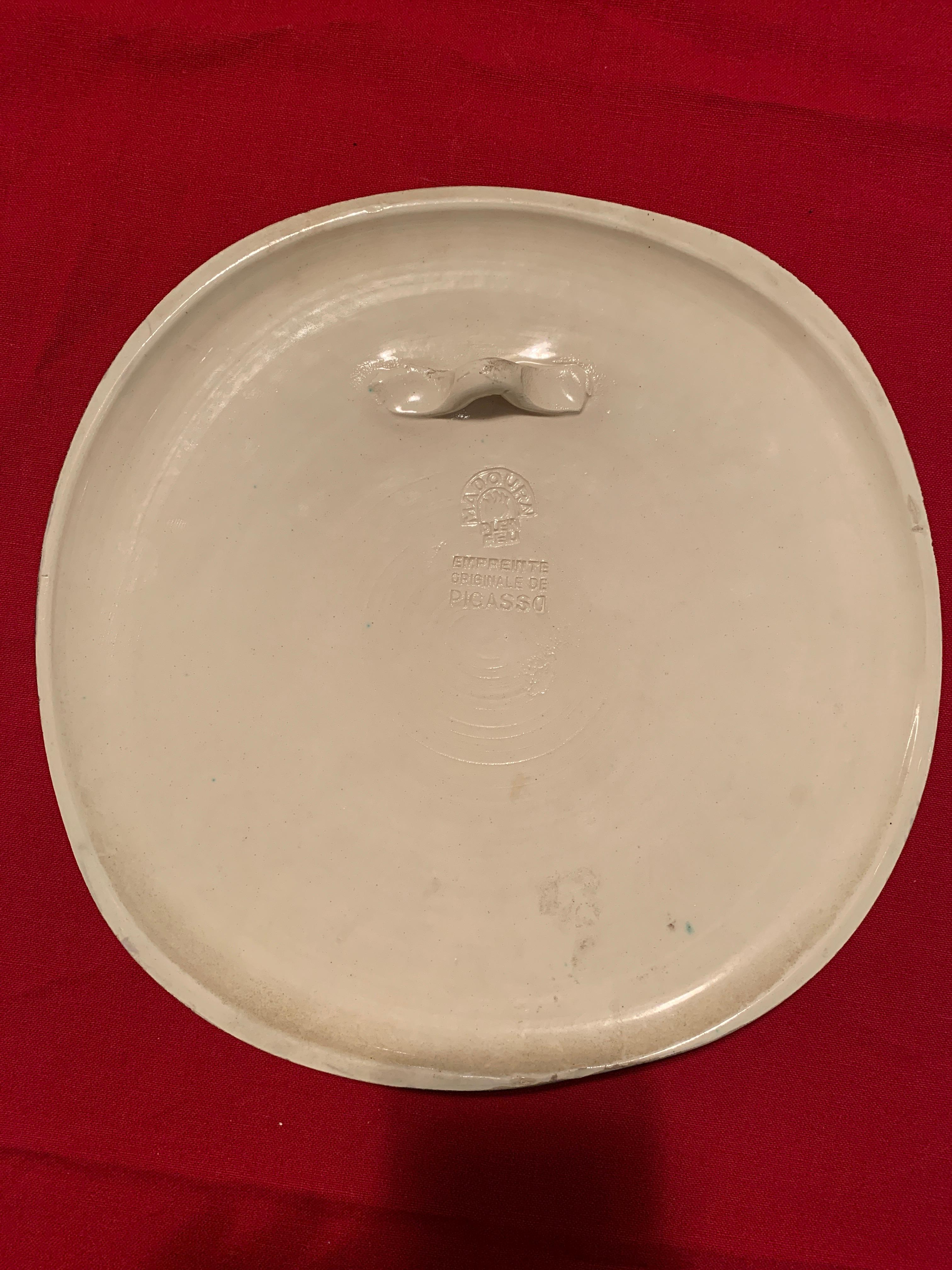 Partially glazed terre-de-faïence convex wall plaque painted in black and white. From an edition of 450, with the Madoura Plein Feu and Empreinte Originale de Picasso stamps on verso. Catalogue reference: Ramié 313.