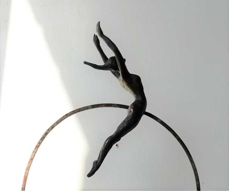 Bauhus is a bronze sculpture with black patina, it is connected to a steel base. The edition size is 25. This sculpture stands on shelf as well as be hung on wall. Joan wants to depict the sense of freedom and free will by capturing the flying pose