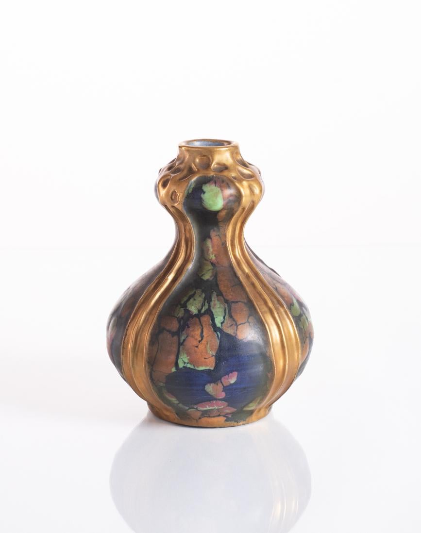 From the Amphora series that came to be known as the Confetti Decor; a delightfully petite vase featuring cobalt underglaze painting with large crackling that reveals spots of green, orange, and pink, and thick threads of gold to compliment the