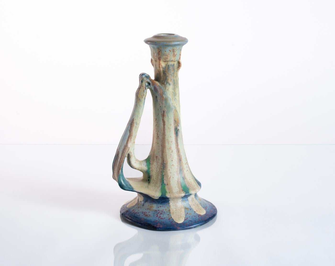 Biomorphic candlestick with experimental glaze produced by RStk Amphora c. 1900, a design attributed to Paul Dachsel. Hand-signed in the base with an RStK marking indicating that this piece was hand-finished on the potter's wheel. 

Riessner,