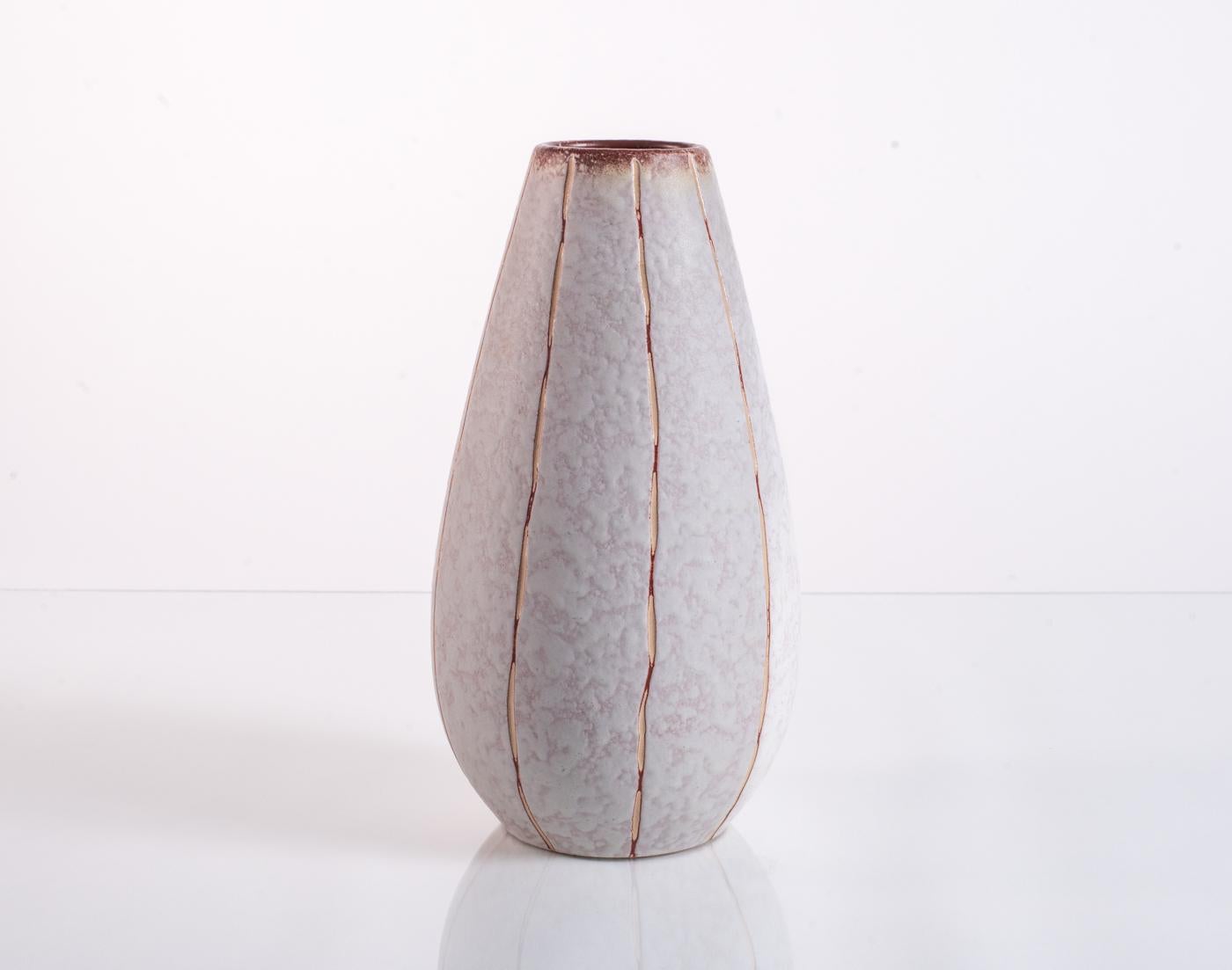 A minimalist ceramic cone vase by Ü-Keramik (Uebelacker) with rugged vertical striations against a pink and white mottled glaze. Numbered in the base. Form 455/25.

Ü Keramik, or Üebelacker Keramik, was founded in 1909 in West Germany by Johann