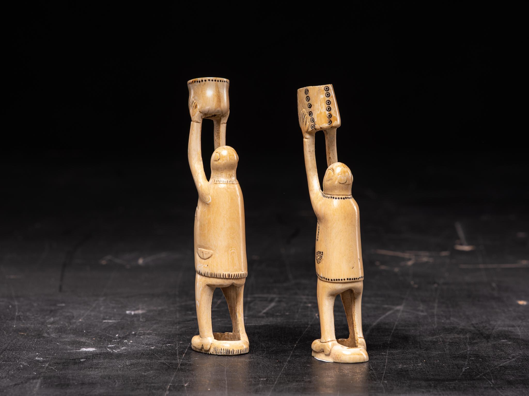 This pair is a fine example of ivory carving done by Inuit natives; Native Americans who live within and just below the Arctic Circle. Each year they procured a substantial amount of ivory from their walrus kills. The raw ivory was usually thrown on