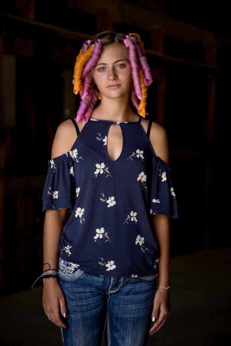 Mark Cáceres Figurative Photograph - "Girl in Curlers, Iowa State Fair" - Southern Portrait Photography