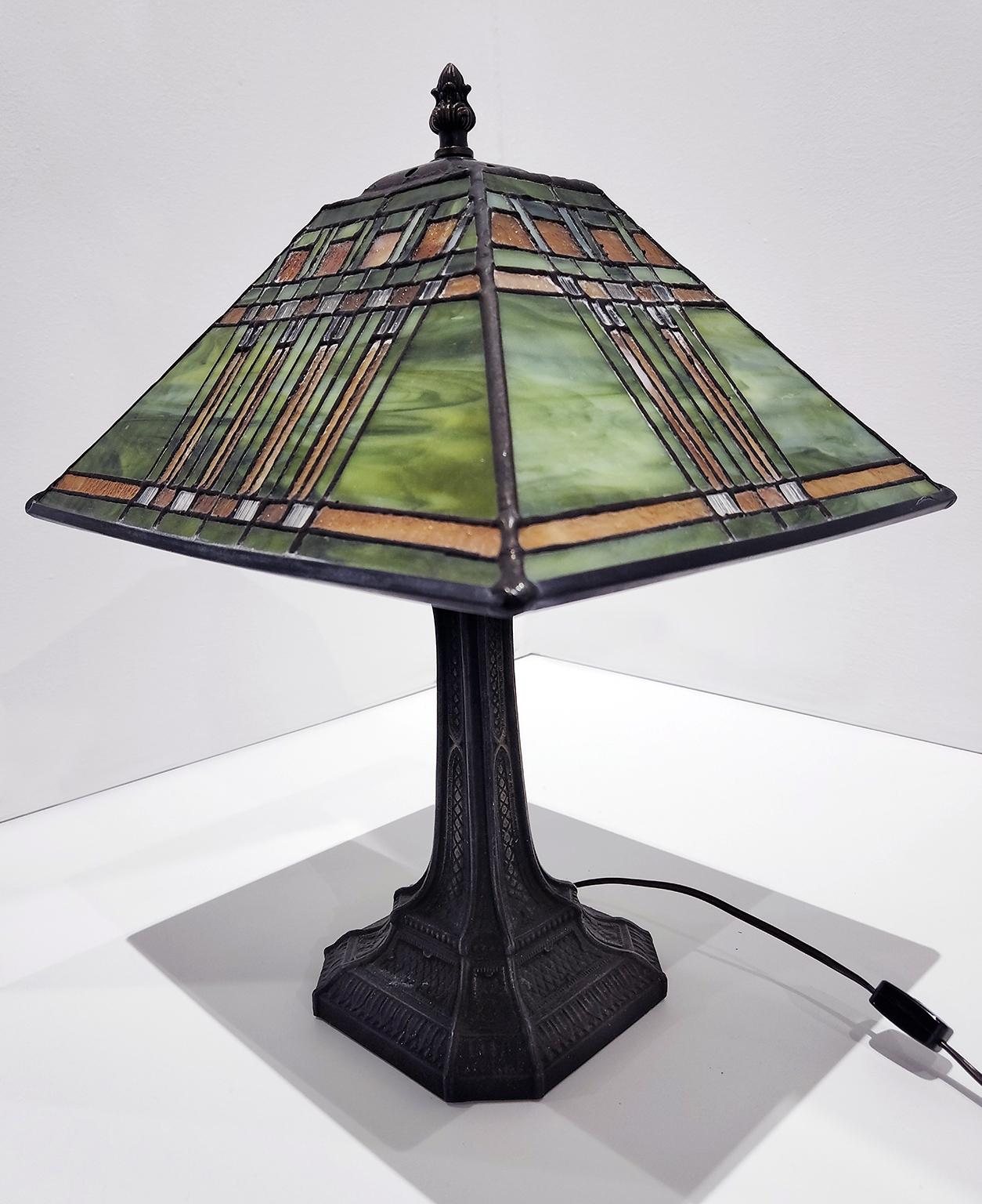 17.5-inch high, four-sided stained glass and bronze table lamp from Richard Hoosin Studio with incandescent bulb. Inscribed Hoosin and dated 98 on top of shade.  