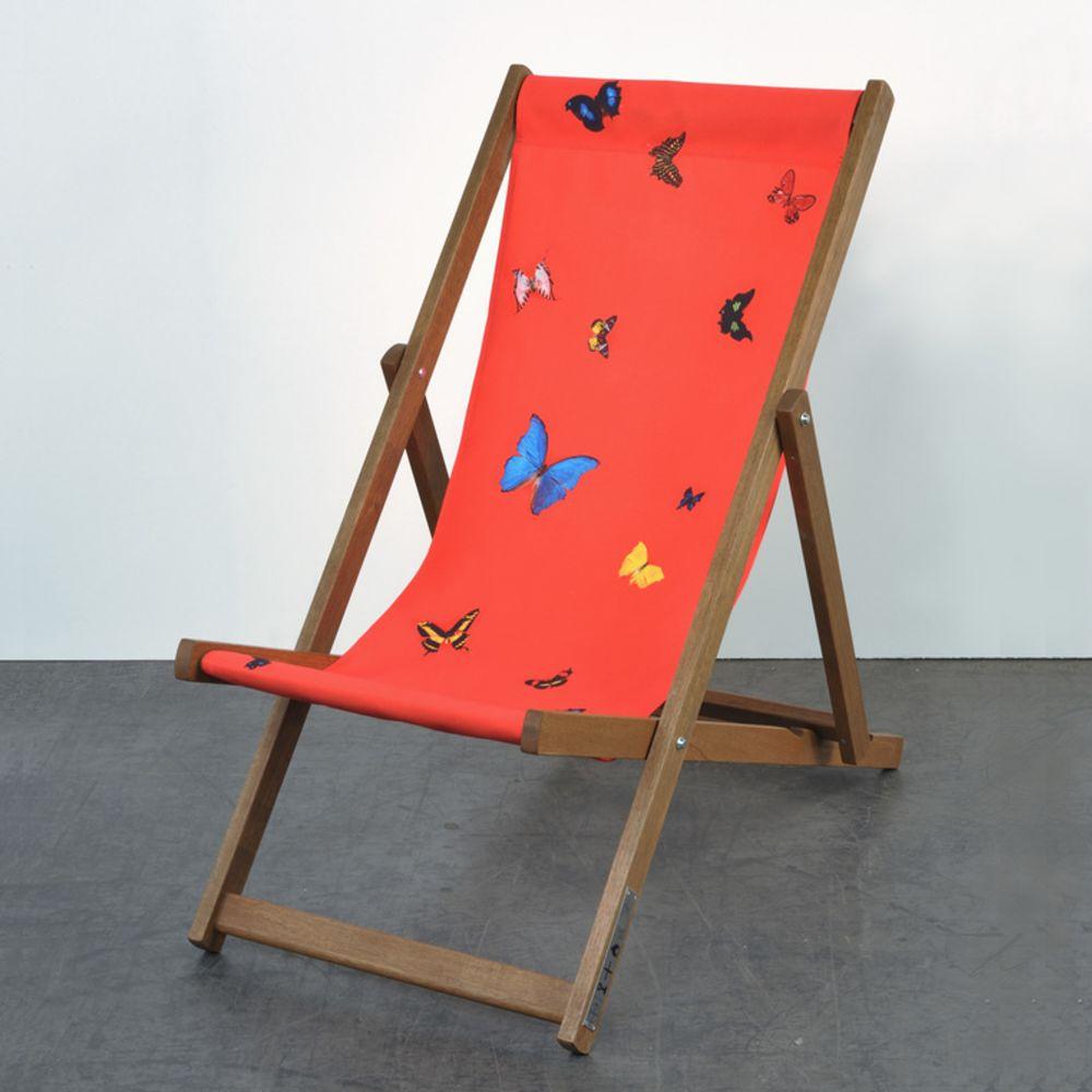 Hirst's Deckchairs use one of the artist's familiar motifs: a monochromatic background interrupted by a scattering of butterflies freezed in an eternal position. 

Damien Hirst
Deckchair (Red) - Contemporary art, 21st Century, Red, Design,