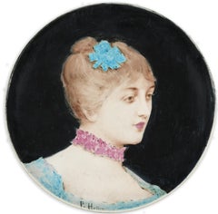 A circular dish decorated by Paul Helleu with a Portrait of a Woman