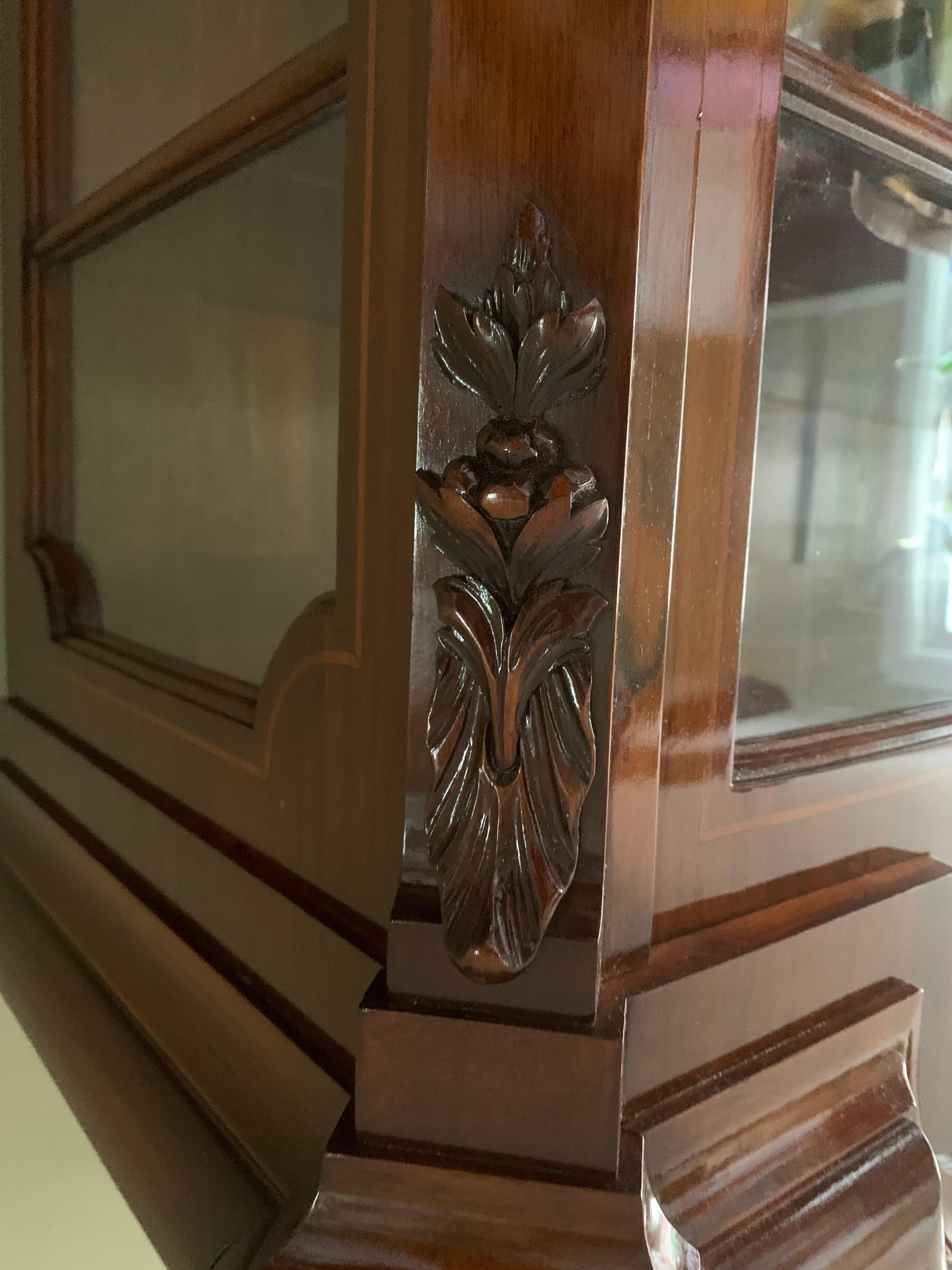 This is a beautiful large antique breakfront China cabinet made from a solid cherry colored Mahogany. It has wings with glass that open on each side. Comes with one key to lock and open. 

This vintage piece is from the early 20th century and over