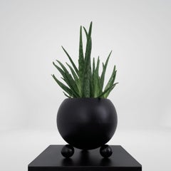 Arty decorative hand-made plant pot, black with black glossy legs