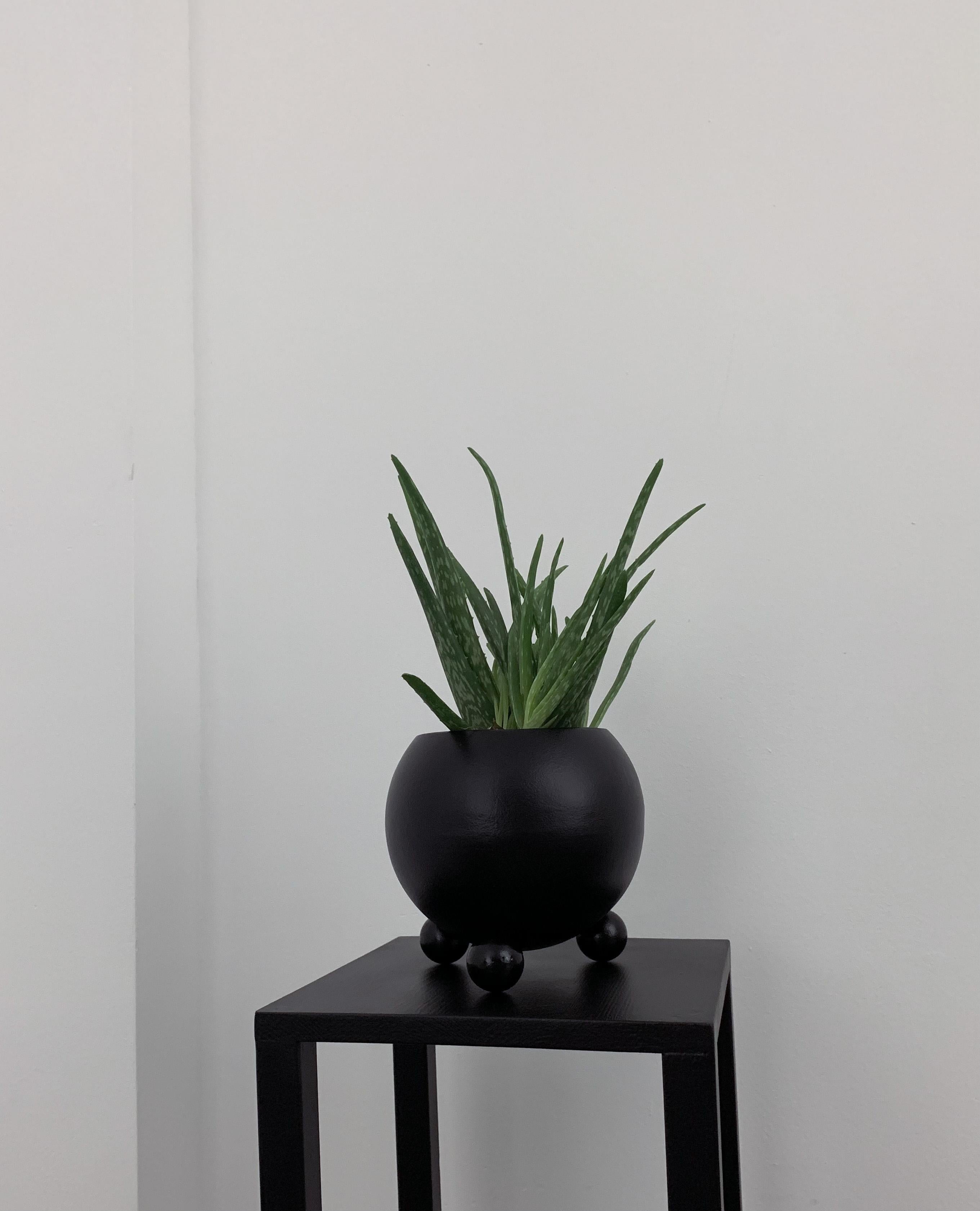 Arty decorative hand-made plant pot, black with black glossy legs 1