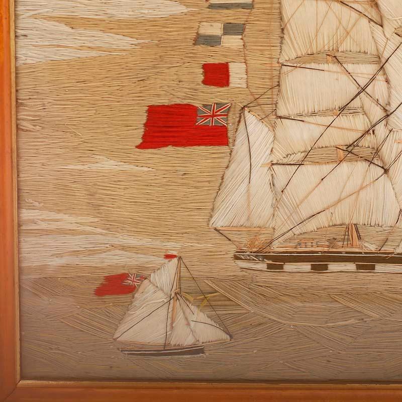 Large antique needlepoint of the British sailing ship Amelia hand crafted in wool, popularly known as woolies, crafted with ambitious detail. Presented under glass in a maple frame and having a bit of her history preserved on the back.