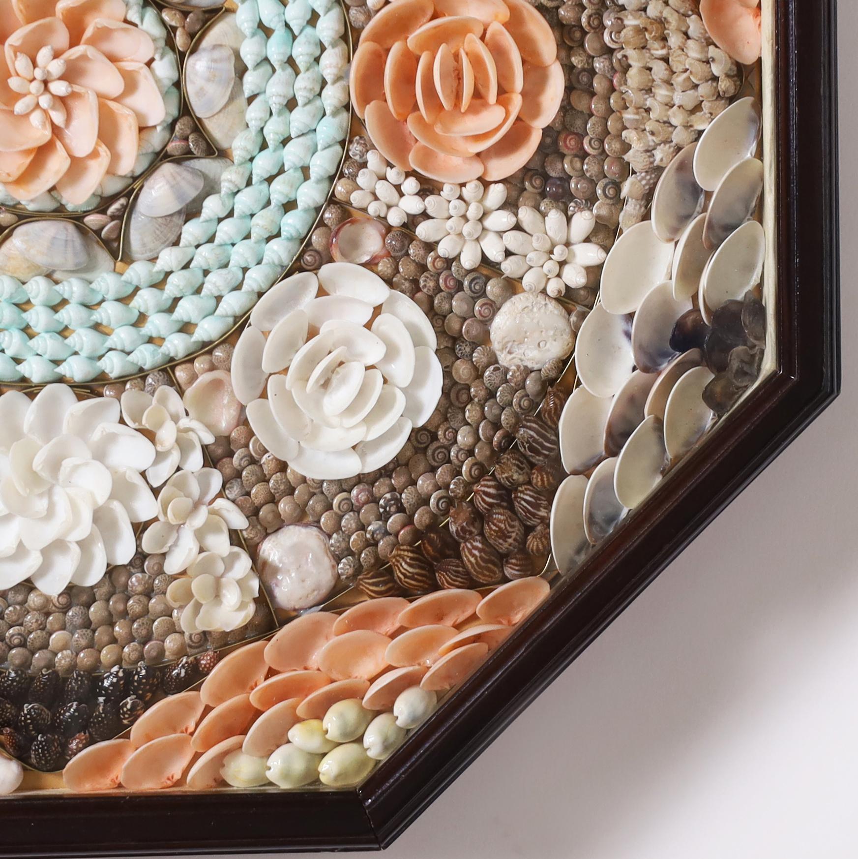 Striking sailors valentine handcrafted with exotic organic seashells in an ambitious floral composition and presented in an octagon ebonized shadow box. 